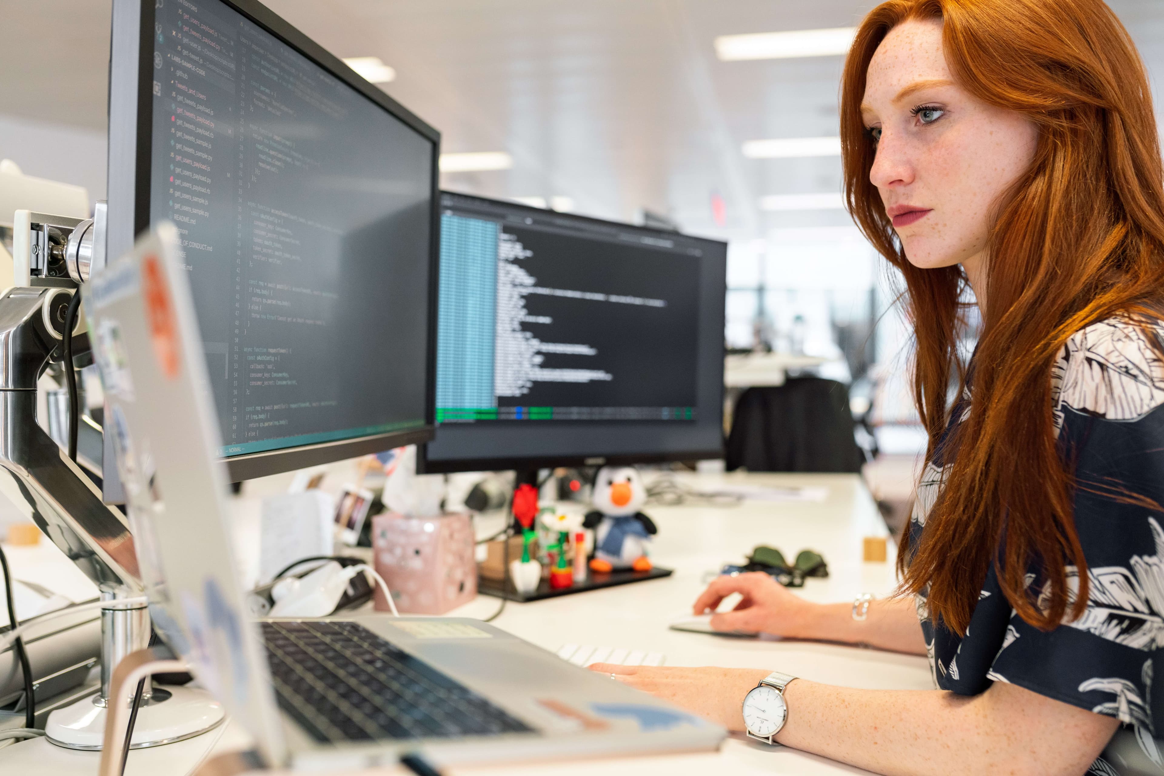 woman working at computer alone - gender bias in the workplace can cause employee isolation