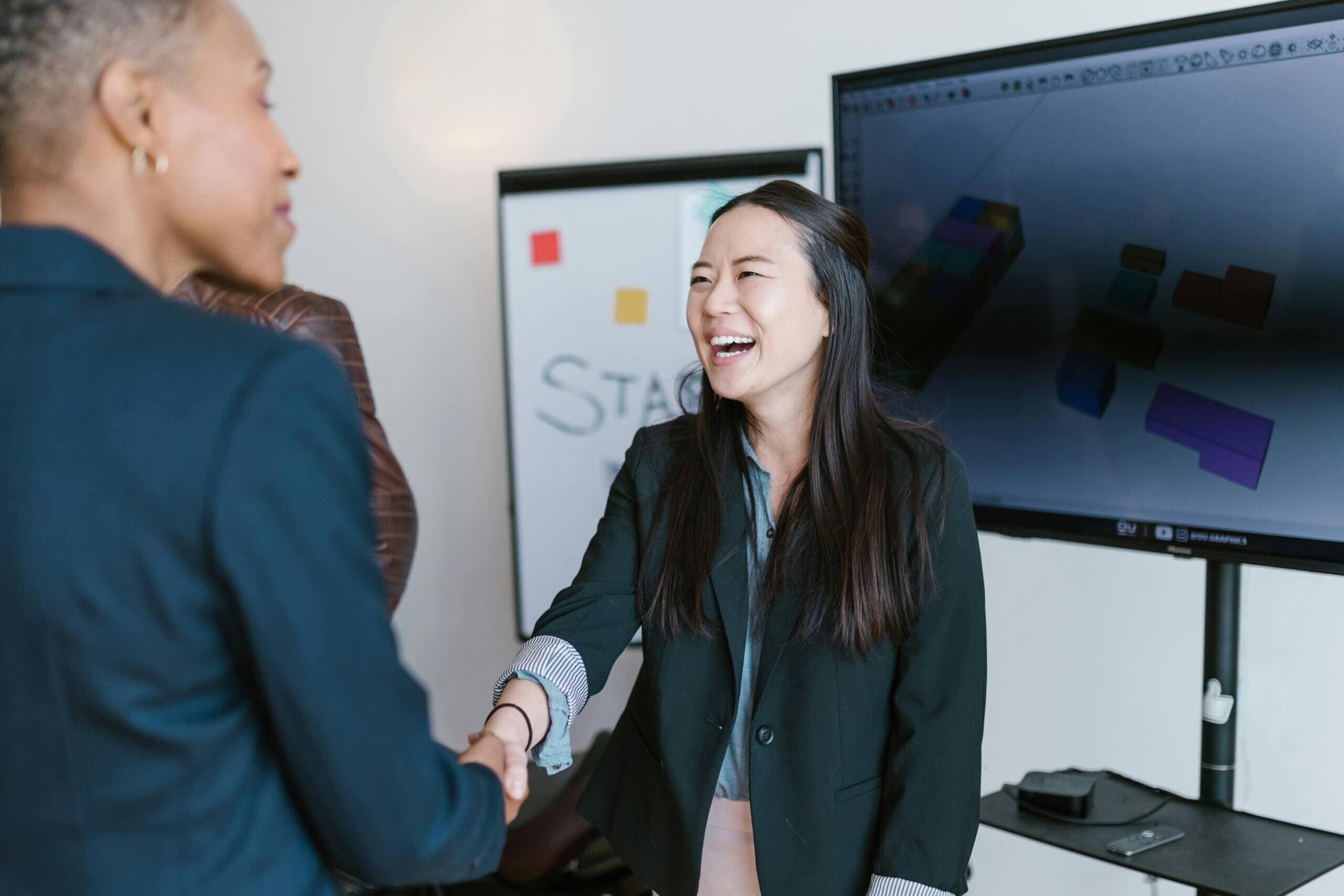 Colleagues shaking hands during a workshop