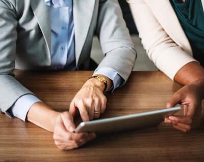 Coworkers collaborate on tablet device