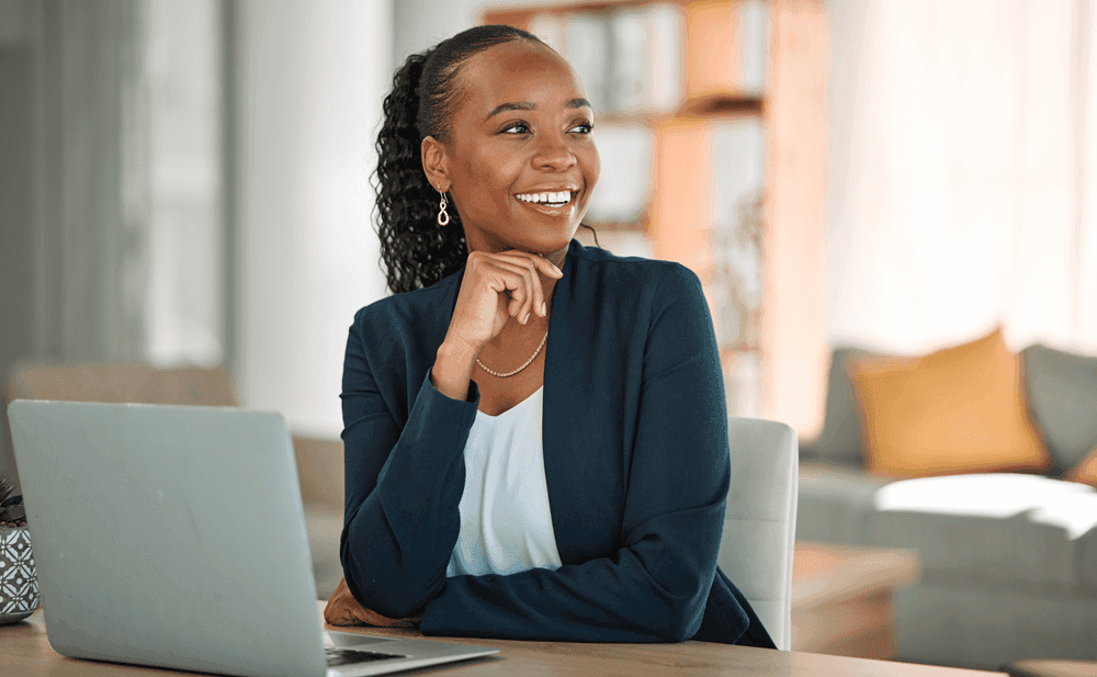 Female employee looking happy with open laptop